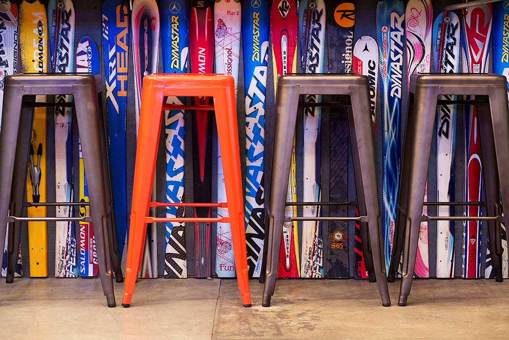colored stools in front of ski linedd bar