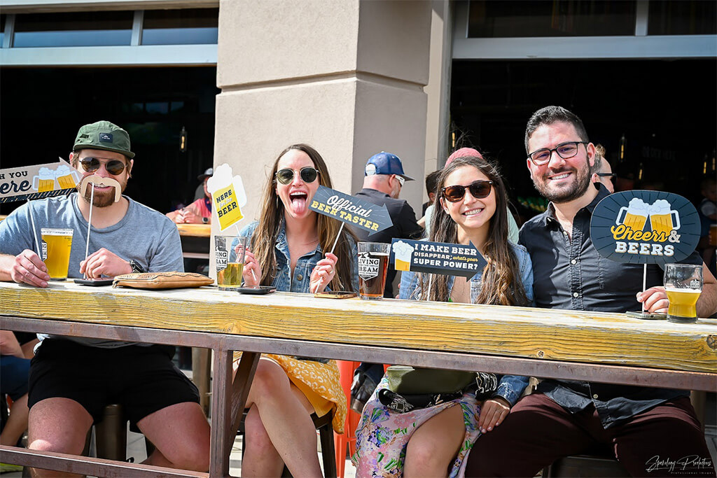 group of friends drinking beer on the patio of our Highlands Ranch location